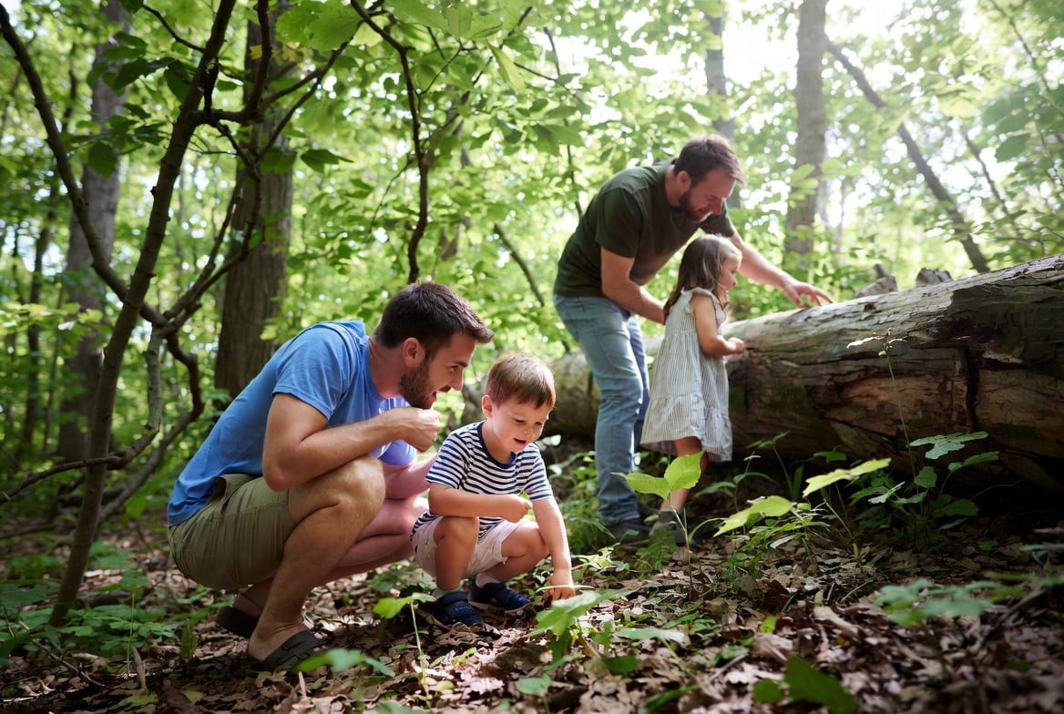 Adventure Guides dads and kids exploring the woods together